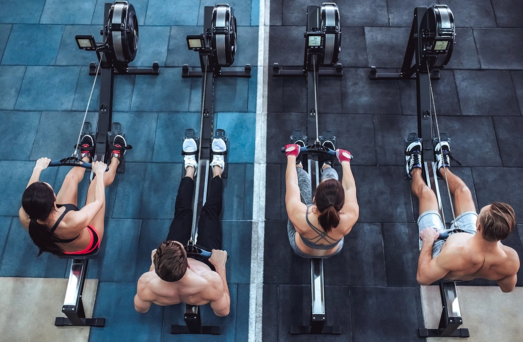 Photo of men and woman working out in the gym